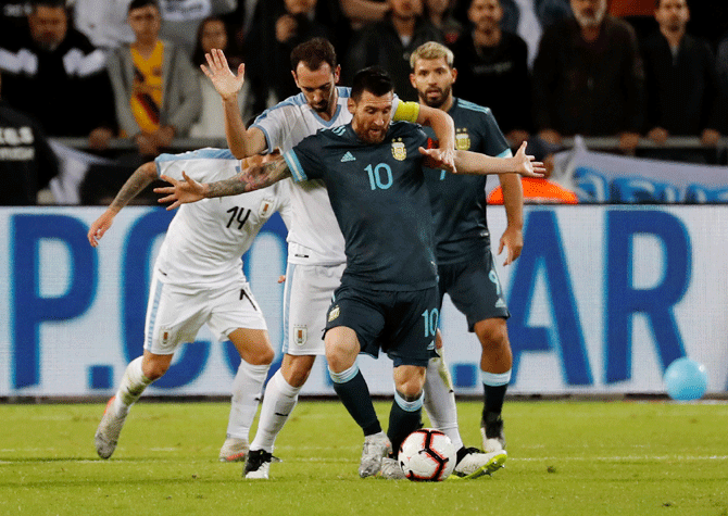 Argentina's Lionel Messi in action with Uruguay's Diego Godin during their international friendly at Bloomfield Stadium in Tel Aviv in Israel on Monday