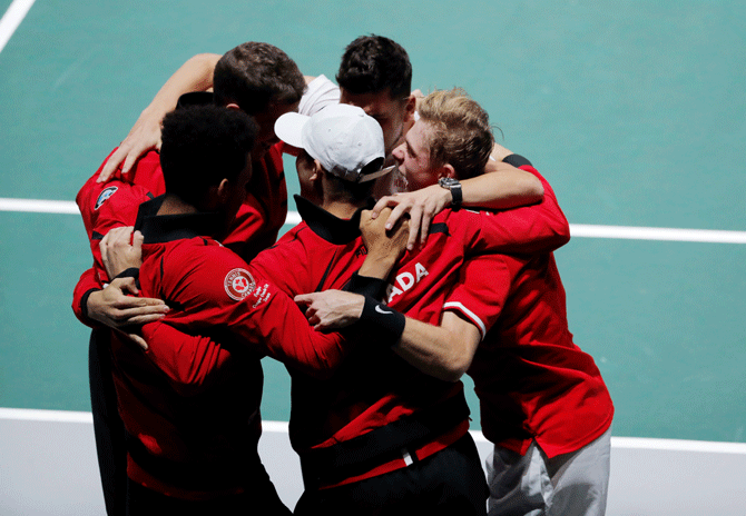 Canada's Denis Shapovalov celebrates with teammates after winning his Davis Cup group stage match against USA's Taylor Fritz