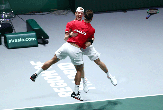 Canada's Vasek Pospisil and Denis Shapovalov celebrate after winning their doubles match against Russia's Karen Khachanov and Andrey Rublev in the Davis Cup semi-final at Caja Magica in Madrid on Saturday