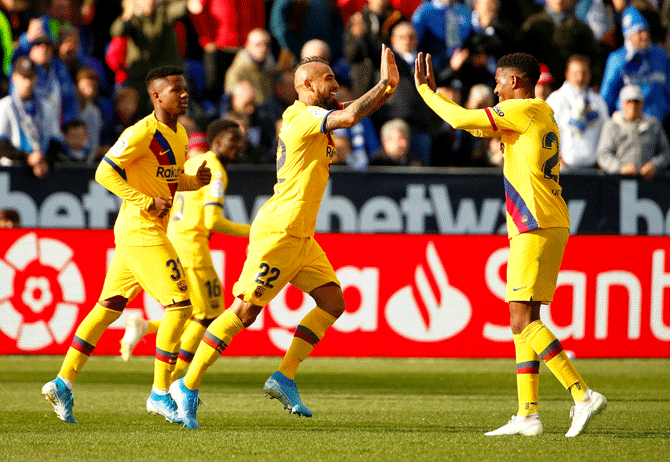 Arturo Vidal celebrates with teammates after scoring Barcelona's second goal against Leganes at Estadio Municipal de Butarque in Leganes