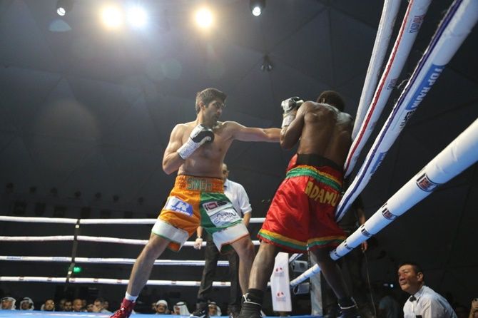 Vijender Singh has Ghana's Charles Adamu on the ropes during Friday night's fight in Dubai.