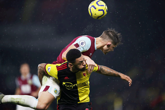 Watford's Andre Gray in an aerial challenge with Burnley's James Tarkowski at Vicarage Road, Watford