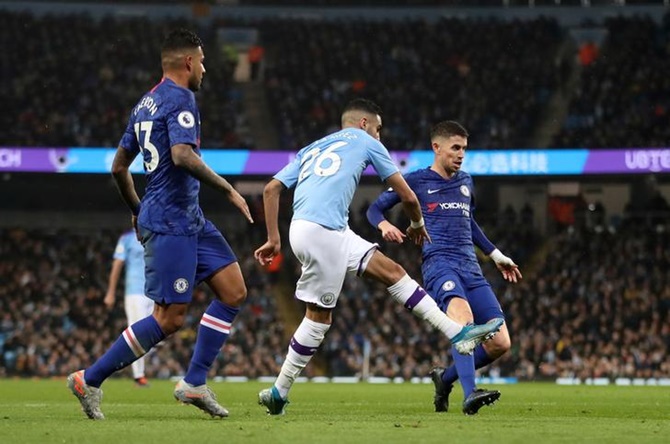 Riyad Mahrez scores Manchester City's second goal in Saturday's Premier League match against Chelsea