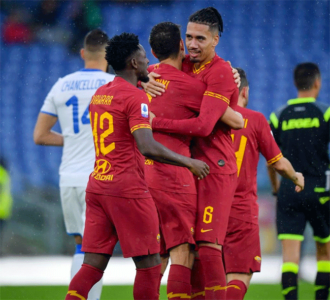 AS Roma's Chris Smalling celebrates with teammates after their Serie A match against Brescia on Sunday