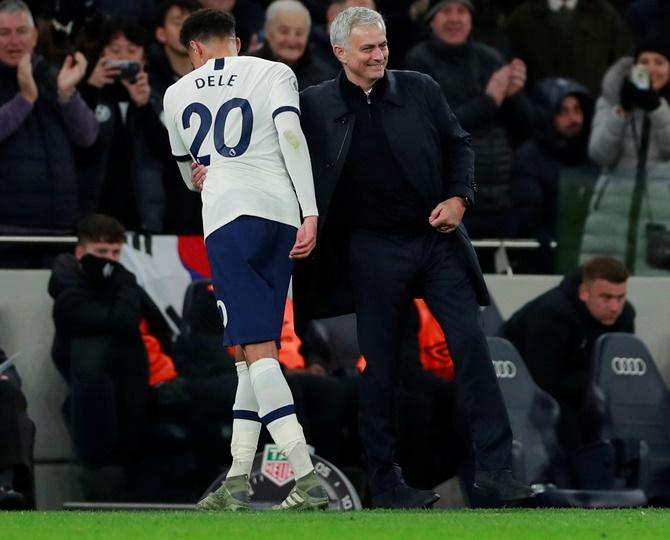 Tottenham Hotspur's Dele Alli gets a pat from manager Jose Mourinho