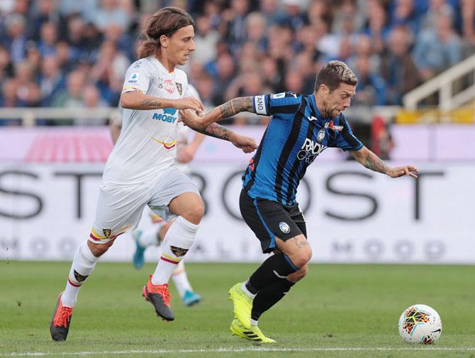 Atalanta's Alejandro Gomez is challenged by US Lecce's Jacopo Petriccione during their Serie A match at Gewiss Stadium in Bergamo, Italy, on Sunday