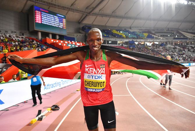 Kenya's Timothy Cheruiyot poses as he celebrates winning gold in the Men's 1500 Metres Final