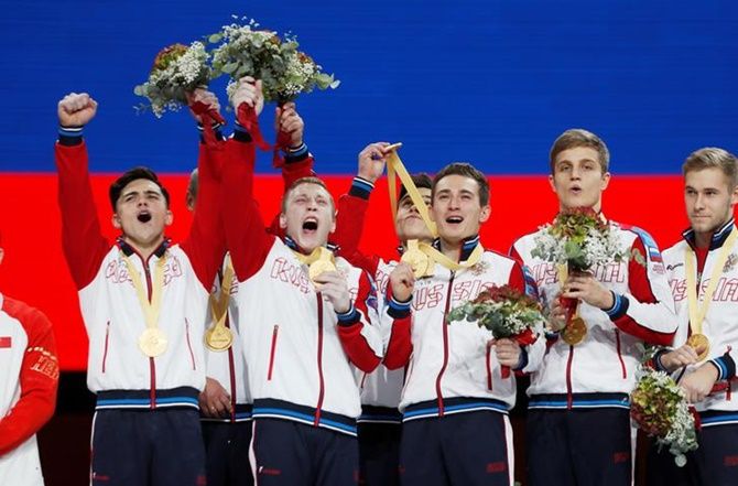 Russia's gymnasts celebrate on the podium after winning the men's team gold.