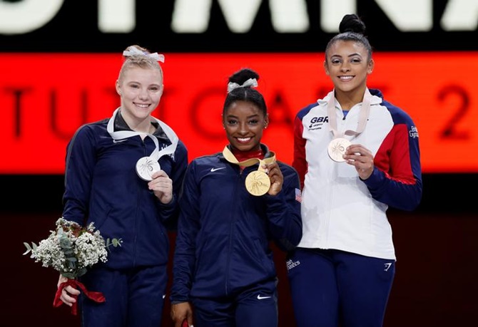 Silver medalist Jade Carey, gold medalist Simone Biles and bronze medalist Elissa Downie pose after the women's Vault medals ceremony.
