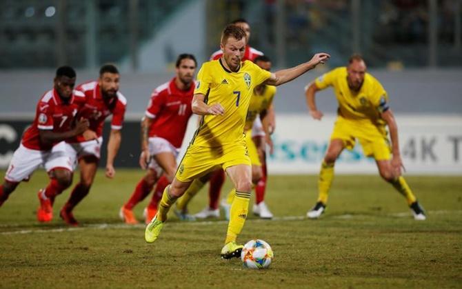 Sebastian Larsson steps up to take a penalty kick and score Sweden's second goal.