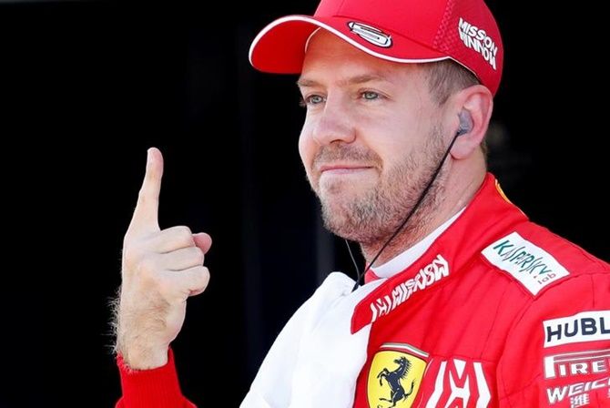 Ferrari's Sebastian Vettel celebrates after qualifying in pole position in the Japanese Grand Prix, at Suzuka Circuit, on Sunday morning.