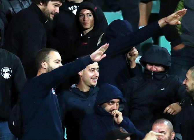 A group of black-clad Bulgarian fans, some of whom were making right-wing salutes, were moved from an area behind the dugout during the Euro qualifier between Bulgaria and England in Sofia on Monday