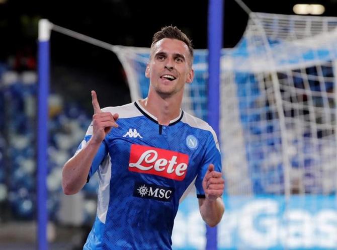 Arkadiusz Milik celebrates scoring Napoli's opening goal against Hellas Verona.