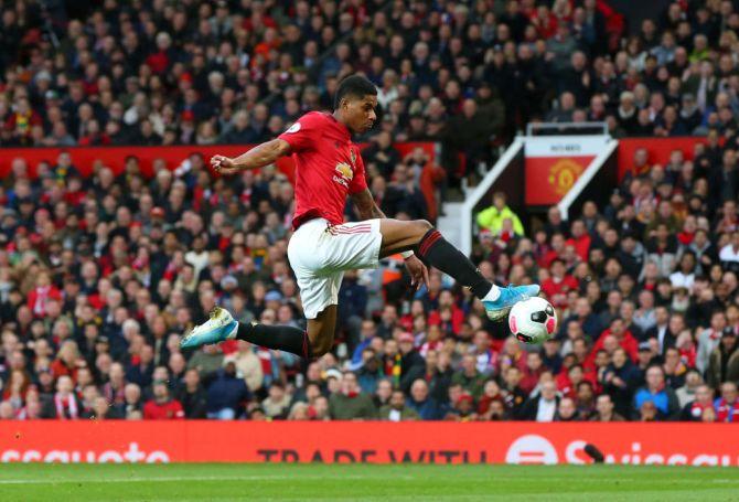 Manchester United's Marcus Rashford scores the opening goal 