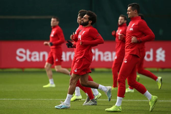 Mohamed Salah warms up with team-mates during a Liverpool training session ahead of the Champions League group E match against KRC Genk at Melwood Training Ground in Liverpool on Tuesday
