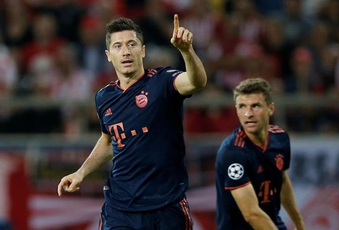 Robert Lewandowski waves to the crowd after scoring Bayern Munich's first goal in the  Group B match against Olympiacos