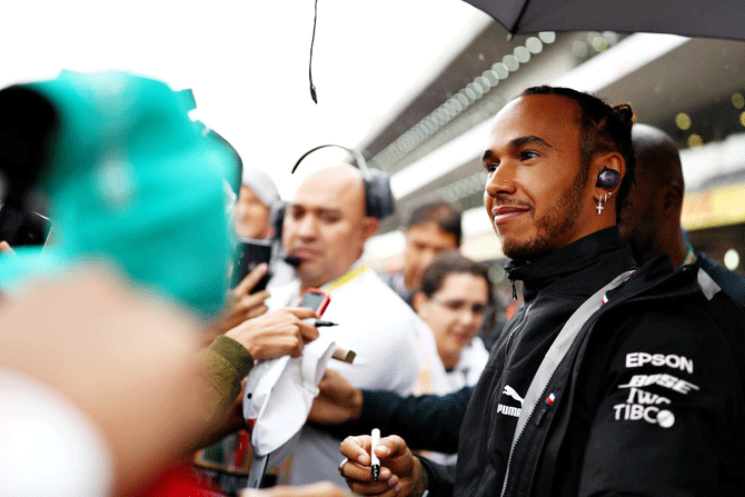 Mercedes GP's British drver Lewis Hamilton signs autographs for fans during previews ahead of the F1 Grand Prix of Mexico at Autodromo Hermanos Rodriguez in Mexico City, Mexico, on Thursday