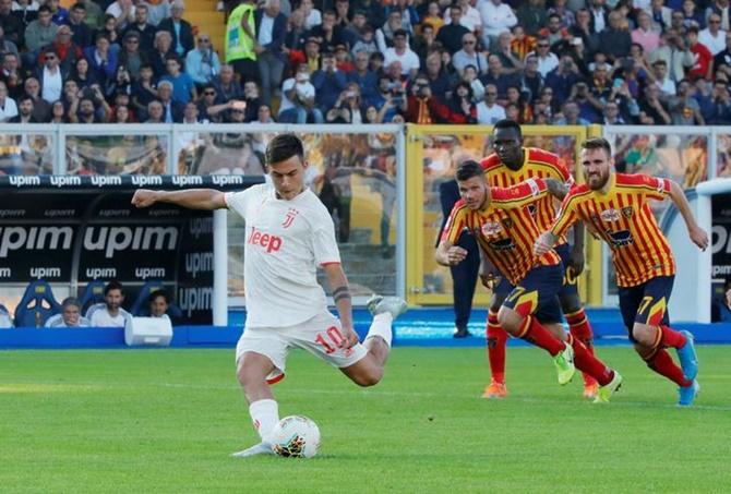 Paulo Dybala puts Juventus ahead from the penalty spot in Saturday's Serie A match against Lecce.