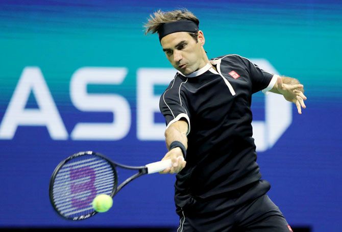Roger Federer returns a shot against Grigor Dimitrov