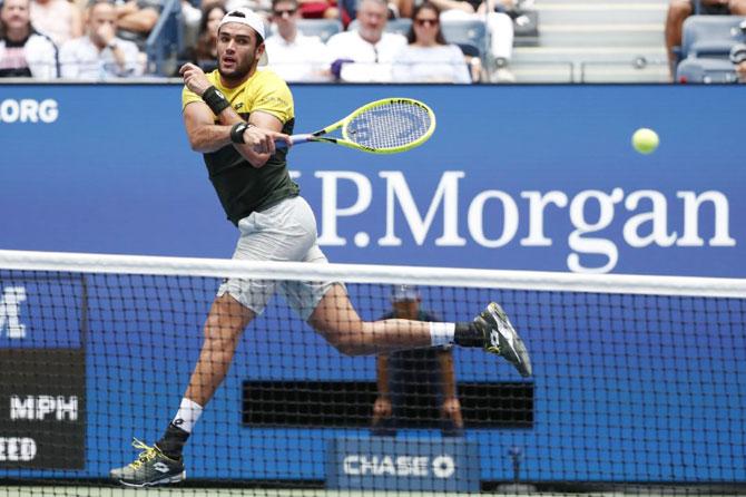 Matteo Berrettini returns a volley against Gael Monfils