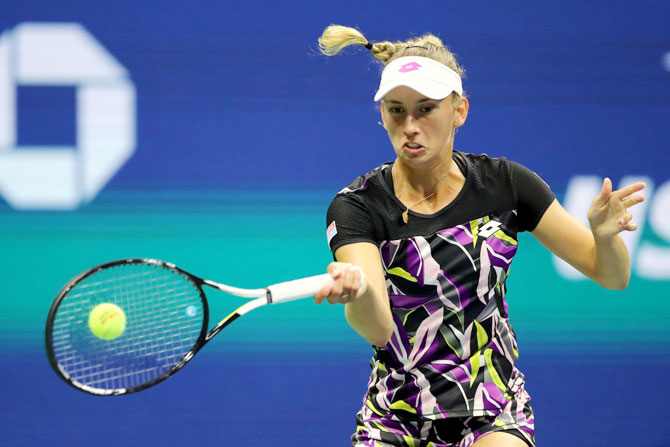 Belgium's Elise Mertens plays a return against Bianca Andreescu