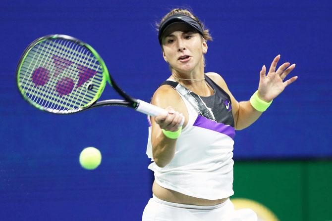 Belinda Bencic returns a shot against Bianca Andreescu