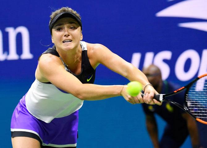 Elina Svitolina stretches to make a backhand return against Serena Williams