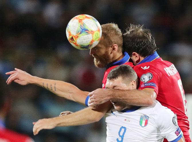 Armenia's Karlen Mkrtchyan and Varazdat Haroyan vie with Italy's Andrea Belotti during their Euro 2020 Qualifier Group J match at Vazgen Sargsyan Republican Stadium in Yerevan, Armenia on Wednesday