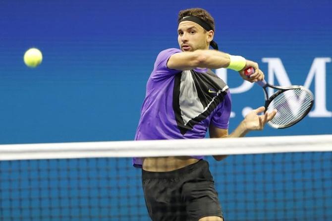 Grigor Dimitrov hits a forehand against Daniil Medvedev.