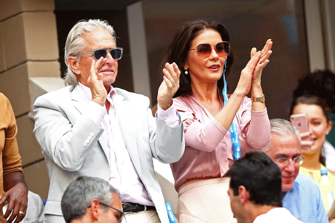 Actor Michael Douglas and wife Catherine Zeta-Jones were off their seats during the entertaining US Open final