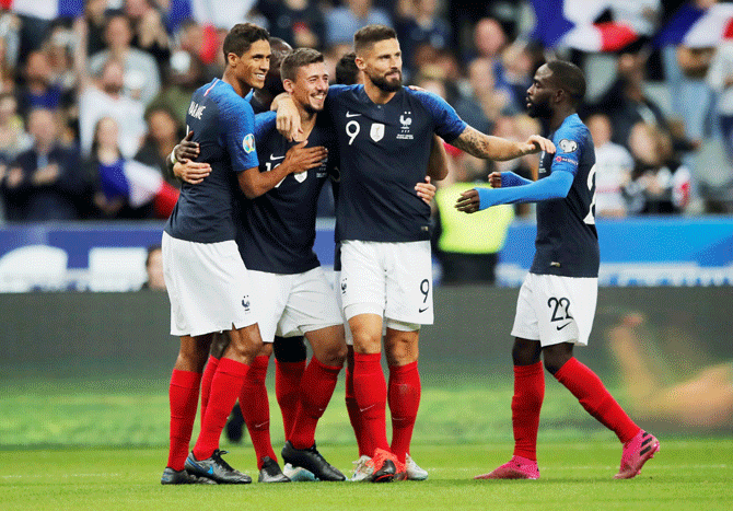 France's Clement Lenglet celebrates with Olivier Giroud and teammates after scoring their second goal against Andorra in their Euro 2020 Qualifier Group H match at Stade De France in Saint-Denis, France, on Tuesday