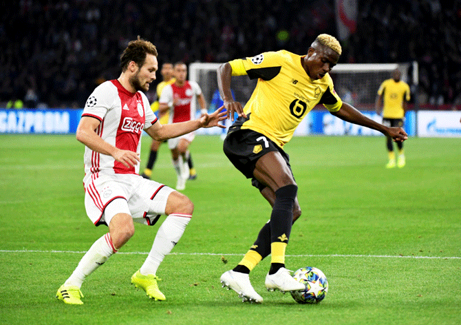 Lille's Victor Osimhen wins possession as he duels with Ajax's Daley Blind during their Champions League Group H match at Johan Cruijff Arena in Amsterdam