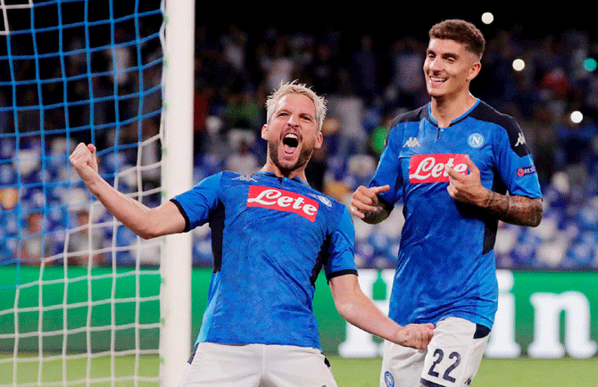 Napoli's Dries Mertens celebrates with Giovanni Di Lorenzo after scoring their first goal against Liverpool at Stadio San Paolo in Naples, Italy, on Tuesday
