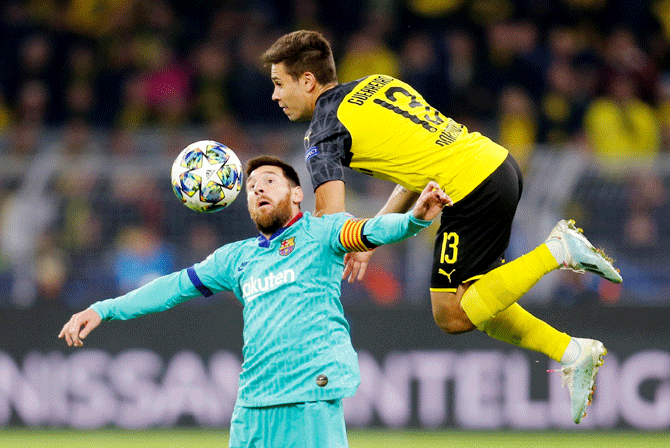Barcelona's Lionel Messi vies with Borussia Dortmund's Raphael Guerreiro during their Champions League  Group F match at Signal Iduna Park in Dortmund
