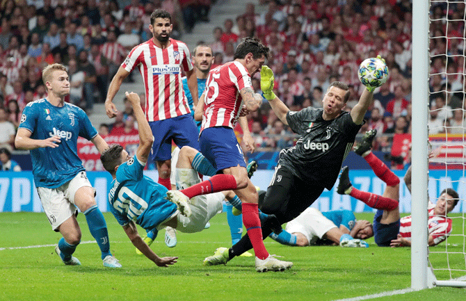 Atletico Madrid's Stefan Savic scores their first goal against Juventus during their Champions League Group D match at Wanda Metropolitano in Madrid on Wednesday
