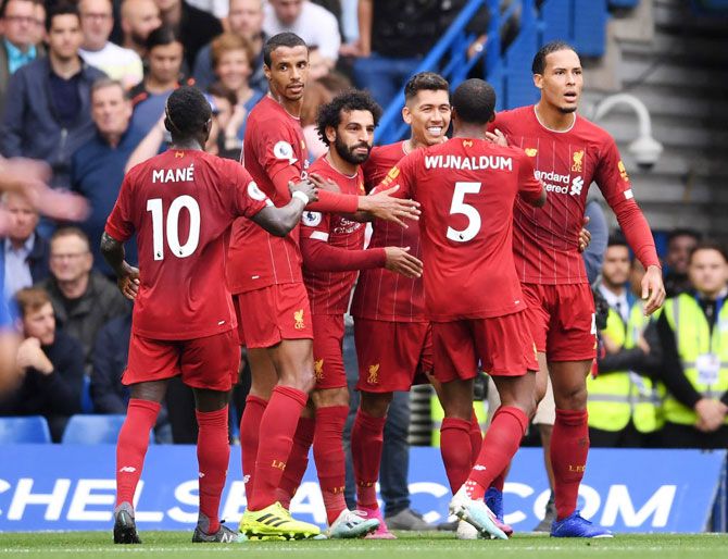 Liverpool's Roberto Firmino celebrates with teammates after scoring his team's second goal against Chelsea at Stamford Bridge