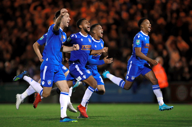 Colchester United players celebrate after winning the penalty shootout against Tottenham Hotspur to win their League Cup match at JobServe Community Stadium, Colchester on Tuesday