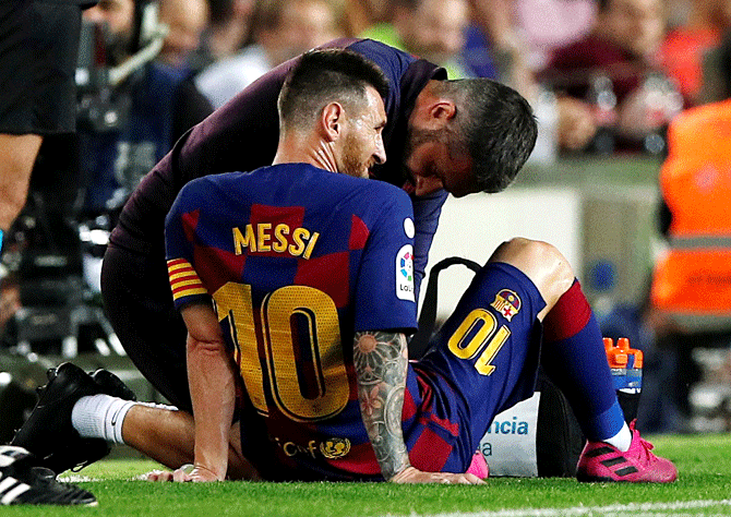 Barcelona's Lionel Messi is attended by medical staff after sustaining an injury during the La Liga match against Villareal at Camp Nou in Barcelona on Tuesday