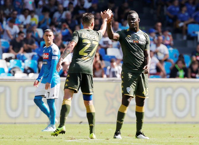 Brescia's Mario Balotelli celebrates with Daniele Dessena after scoring their first goal against Napoli during their Serie A match at Stadio San Paolo in Naples, Italy, on Sunday