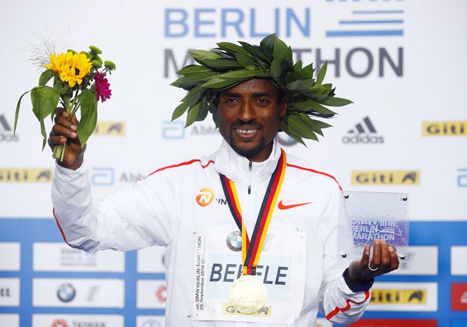 Ethiopia's Kenenisa Bekele celebrates on the podium after winning the men's elite race at the Berlin Marathon in Berlin on Sunday