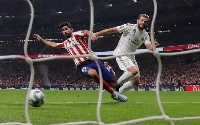 Atletico Madrid's Diego Costa and Real Madrid's Nacho battle for possession.