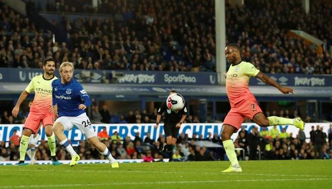 Raheem Sterling scores Manchester City's third goal.