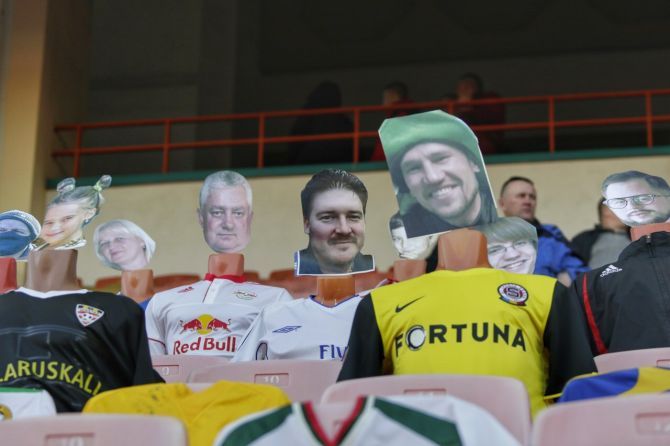 Fans' photos are pasted onto the top half of a fashion dummy sitting inside the stadium during a FC Dynamo Brest match