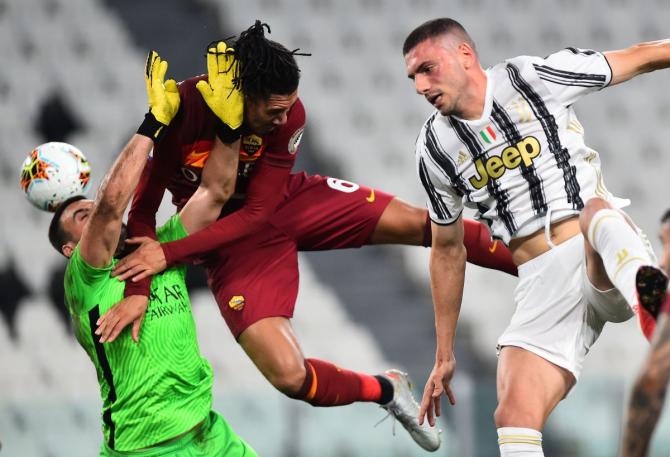 AS Roma's Chris Smalling and Daniel Fuzato in action with Juventus' Merih Demiral