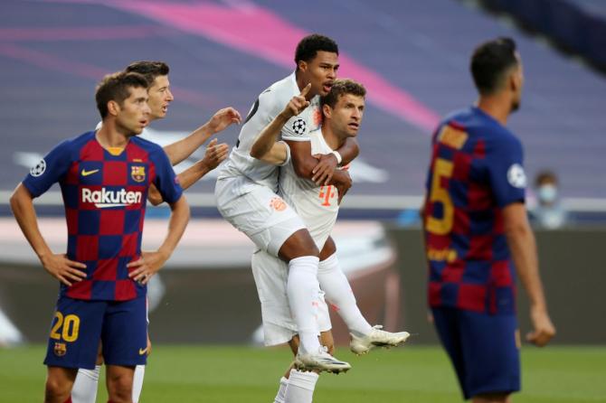 Bayern Munich's Thomas Muller celebrates scoring their first goal with Serge Gnabry