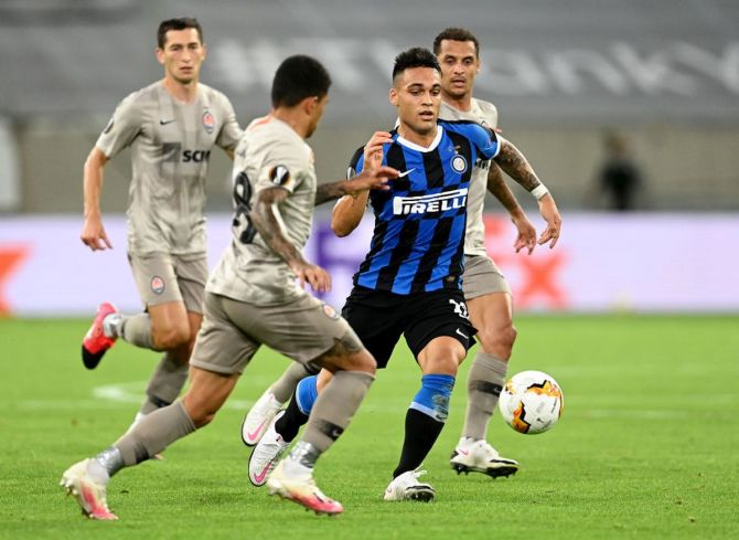 Inter Milan's Lautaro Martinez runs past Shakhtar Donetsk's Marcos Antonio during the UEFA Europa League semi-final at Merkur Spiel-Arena in Duesseldorf on Monday