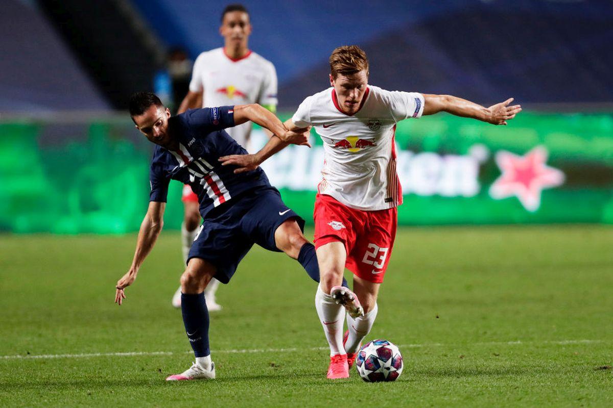 RB Leipzig's Marcel Halstenberg and Paris Saint-Germain's Leandro Paredes battle for possession