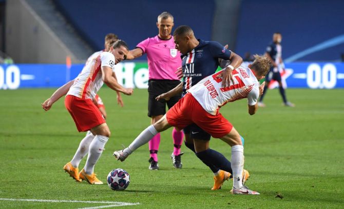 Paris Saint-Germain's Kylian Mbappe is challenged by RB Leipzig's Marcel Sabitzer and Konrad Laimer