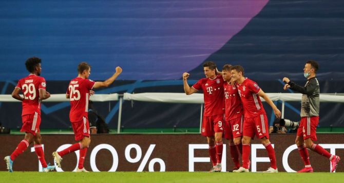 Bayern Munich's Robert Lewandowski celebrates with teammates on scoring their third goal