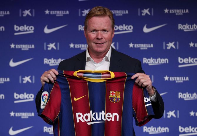 New coach Ronald Koeman poses with a Barcelona shirt during the unveiling ceremony at Auditorium 1899 in Barcelona on Wednesday 